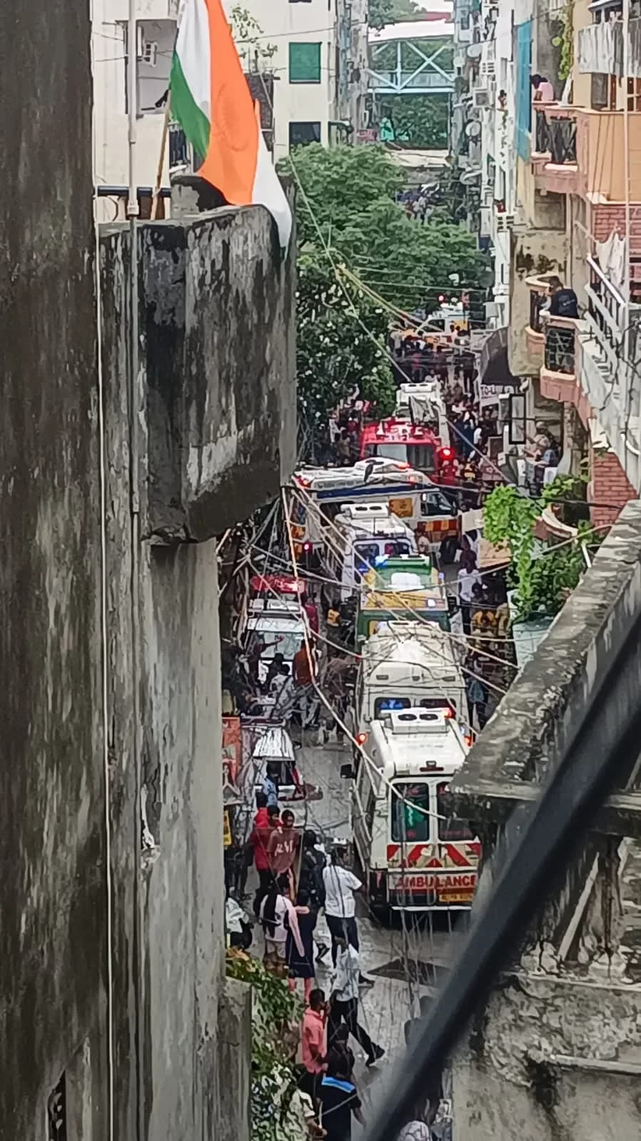 Rescue workers and crowds gathered around the completely collapsed Daze PG building in Delhi's Satya Niketan area.